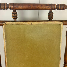 Load image into Gallery viewer, Upholstered in a rich green fabric with hints of orange peeking through, this chair embodies an authentic autumnal aesthetic. The material and inner padding remain in good condition, ensuring style and comfort