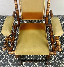 Load image into Gallery viewer, Upholstered in a rich green fabric with hints of orange peeking through, this chair embodies an authentic autumnal aesthetic. The material and inner padding remain in good condition, ensuring style and comfort