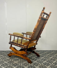 Load image into Gallery viewer, Upholstered in a rich green fabric with hints of orange peeking through, this chair embodies an authentic autumnal aesthetic. The material and inner padding remain in good condition, ensuring style and comfort