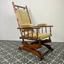 Load image into Gallery viewer, Upholstered in a rich green fabric with hints of orange peeking through, this chair embodies an authentic autumnal aesthetic. The material and inner padding remain in good condition, ensuring style and comfort