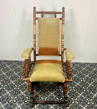 Load image into Gallery viewer, Upholstered in a rich green fabric with hints of orange peeking through, this chair embodies an authentic autumnal aesthetic. The material and inner padding remain in good condition, ensuring style and comfort