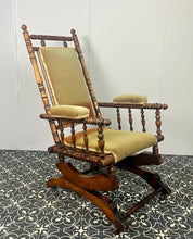 Load image into Gallery viewer, Upholstered in a rich green fabric with hints of orange peeking through, this chair embodies an authentic autumnal aesthetic. The material and inner padding remain in good condition, ensuring style and comfort