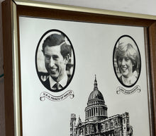 Load image into Gallery viewer, Vibrant mirror featuring the wedding of Charles and Diana on the 29th of July 1981 with a portrait of the couple and intricate picture of St Pauls and the fonts in a banner design.