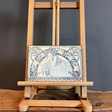 Load image into Gallery viewer, This vintage art nouveau wooden wall plaque, with a blue effect, is a unique piece of art. It features an elegant lady wearing an attractive headdress, her hair tied up, and a selection of glamorous clothing.