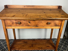 Load image into Gallery viewer, Excellent pitch pine clerk desk with raised back and sloped writing surface over a single fall-front cupboard with key, raised on square supports united by under-tier two plank pine shelf.