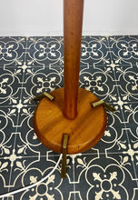Load image into Gallery viewer, Vintage Scandinavian designer Teak Floor Lamp. This stunning teak floor lamp features a circular base with stylish brass details paired with a mustard fabric lamp shade. It is perfect as an additional light in your living room or workspace.