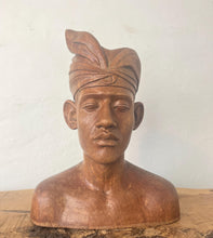 Load image into Gallery viewer, This vintage Balinese teak sculpture features a bust of a man wearing a traditional headdress. With its intricate details and exquisite craftsmanship, this piece is a one-of-a-kind decorative collectable.