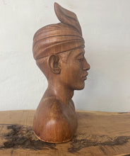Load image into Gallery viewer, This vintage Balinese teak sculpture features a bust of a man wearing a traditional headdress. With its intricate details and exquisite craftsmanship, this piece is a one-of-a-kind decorative collectable.