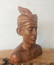 Load image into Gallery viewer, This vintage Balinese teak sculpture features a bust of a man wearing a traditional headdress. With its intricate details and exquisite craftsmanship, this piece is a one-of-a-kind decorative collectable.