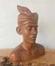Load image into Gallery viewer, This vintage Balinese teak sculpture features a bust of a man wearing a traditional headdress. With its intricate details and exquisite craftsmanship, this piece is a one-of-a-kind decorative collectable.