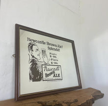 Load image into Gallery viewer, Vibrant Newcastle brown ale mirror with stand out fonts with great picture with a man enjoying his beer, fantastic slogan and interesting information about the prices, with further unique branding information a very stylish piece.
