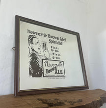 Load image into Gallery viewer, Vibrant Newcastle brown ale mirror with stand out fonts with great picture with a man enjoying his beer, fantastic slogan and interesting information about the prices, with further unique branding information a very stylish piece.