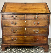 Load image into Gallery viewer, The antique mahogany bureau has a fall front that opens to reveal a writing surface. Its elegant fitted interior consists of six pigeon holes, five drawers on either side, and a central cupboard with Roman columns with a gold detail sitting on desirable runners