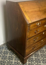 Load image into Gallery viewer, The antique mahogany bureau has a fall front that opens to reveal a writing surface. Its elegant fitted interior consists of six pigeon holes, five drawers on either side, and a central cupboard with Roman columns with a gold detail sitting on desirable runners
