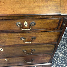 Load image into Gallery viewer, The antique mahogany bureau has a fall front that opens to reveal a writing surface. Its elegant fitted interior consists of six pigeon holes, five drawers on either side, and a central cupboard with Roman columns with a gold detail sitting on desirable runners