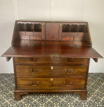 Load image into Gallery viewer, The antique mahogany bureau has a fall front that opens to reveal a writing surface. Its elegant fitted interior consists of six pigeon holes, five drawers on either side, and a central cupboard with Roman columns with a gold detail sitting on desirable runners