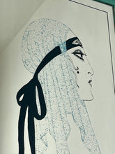 Load image into Gallery viewer, A collectible advertising piece featuring a glamorous lady in a vintage-style scarf bandana with her ribbon flowing down, posing thoughtfully. The mirror has a stylish feel and a noir finish with hint if colour. It is an excellent wall art piece to add a nice touch to your home.