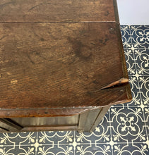 Load image into Gallery viewer, The antique oak coffer is of simple, plain form and has a hinged lid that opens to reveal a spacious interior. The coffer has a three-panel front and is raised on block feet. One of my favourite parts is the back panel that has been crudely chiselled from one section of oak, with an excellent, authentic craftsmanship finish.