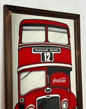 Load image into Gallery viewer, The mirror prominently features a red London double-decker bus with TRAFALGAR SQUARE and 12 on its destination sign, and Coca-Cola branding on the side of the bus. The license plate reads LON 80.