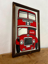 Load image into Gallery viewer, The mirror prominently features a red London double-decker bus with TRAFALGAR SQUARE and 12 on its destination sign, and Coca-Cola branding on the side of the bus. The license plate reads LON 80.