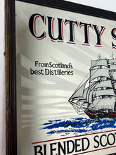 Load image into Gallery viewer, The mirror features the iconic image of the Cutty Sark clipper ship, a renowned tea clipper launched in 1869, which inspired the whisky's name. It also states "From Scotland's best Distilleries" and "86 Proof" (which translates to 43% ABV).