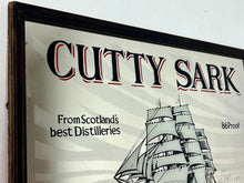 Load image into Gallery viewer, The mirror features the iconic image of the Cutty Sark clipper ship, a renowned tea clipper launched in 1869, which inspired the whisky's name. It also states "From Scotland's best Distilleries" and "86 Proof" (which translates to 43% ABV).