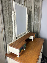 Load image into Gallery viewer, Beautiful vintage shabby chic dressing table with a stylish mirror and sleek drawers. This piece features a painted finish country cream with a contrasting natural wooden top, its distinctive floral patterned drawer fronts add a unique touch.