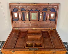 Load image into Gallery viewer, A beautiful Anglo-Indian Marriage Dowry chest circa 1900 with campaign handles and original wooden wheels, a very well-crafted and decorative chest, decorated with brass inlaid wire work, classically indicative of Indian artistry. This piece is a fine example of an Anglo-Indian chest. Designed as a dowry piece to be given by the father of the bride in an Indian wedding, you would have gold, jewellery, land deeds, money and fine linens stored inside.