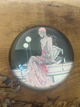 Load image into Gallery viewer, Beautiful vintage glass paperweight in Art Deco style, featuring an illustration of a lady in a pink dress and headpiece. This particular style, often associated with the roaring twenties, is characterised by its elegant and sophisticated portrayal of women, usually referred to as flapper ladies or Gatsby ladies.