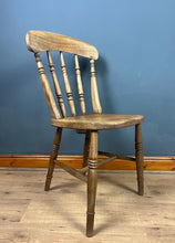Load image into Gallery viewer, This style is a type of Windsor chair, a design that originated in England in the early 18th century and is characterised by its solid wooden seat into which the legs and spindles of the back are inserted.