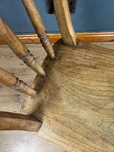 Load image into Gallery viewer, This style is a type of Windsor chair, a design that originated in England in the early 18th century and is characterised by its solid wooden seat into which the legs and spindles of the back are inserted.