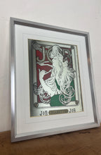 Load image into Gallery viewer, The woman’s hair, wild and swirling through a play of ornate interweaving lines, is a typical Mucha style feature. When this was created, women generally did not smoke in public and usually wore their hair up, making this a daring and wild piece. The geometric shape repeated in the background is the company’s logo.