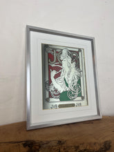 Load image into Gallery viewer, The woman’s hair, wild and swirling through a play of ornate interweaving lines, is a typical Mucha style feature. When this was created, women generally did not smoke in public and usually wore their hair up, making this a daring and wild piece. The geometric shape repeated in the background is the company’s logo.