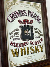 Load image into Gallery viewer, The mirror features vibrant, bold fonts in fabulous colours, with the royal crest in the middle and an intricate golden border. It is presented in a wooden frame and is in vintage condition, with a few signs of authentic patina.