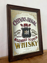 Load image into Gallery viewer, The mirror features vibrant, bold fonts in fabulous colours, with the royal crest in the middle and an intricate golden border. It is presented in a wooden frame and is in vintage condition, with a few signs of authentic patina.