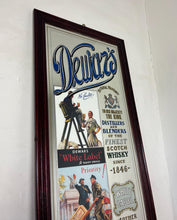 Load image into Gallery viewer, It includes a depiction of a seated Scotsman with a glass of whisky, and another scene below showing men with a cart, which are classic elements of Dewar's vintage advertising campaigns.