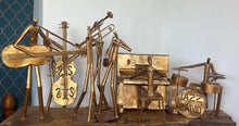 Load image into Gallery viewer, It features abstract, elongated figures of musicians playing various instruments, including a guitar, double bass, trumpet, trombone, saxophone, piano, and drums.