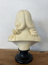 Load image into Gallery viewer, The figure depicts a young woman with wavy hair gathered into ringlets over her shoulders, wearing a draped garment with spaghetti straps and rosette detailing. Her facial expression is serene with downcast eyes.