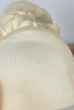 Load image into Gallery viewer, The figure depicts a young woman with wavy hair gathered into ringlets over her shoulders, wearing a draped garment with spaghetti straps and rosette detailing. Her facial expression is serene with downcast eyes.