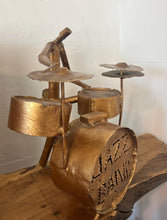 Load image into Gallery viewer, It features abstract, elongated figures of musicians playing various instruments, including a guitar, double bass, trumpet, trombone, saxophone, piano, and drums.