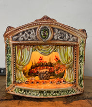 Load image into Gallery viewer, This style of hand-painted, glazed ceramic item, sometimes featuring floral designs or specific scenes, has a whimsical, hand-painted design with a military theme, incorporating several small seated toy figures and a cannon figurine.