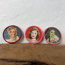 Load image into Gallery viewer, Beautiful mid-century vintage compact mirrors or small circular handbag mirrors featuring pin-up style art from the mid-20th century.