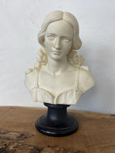 Load image into Gallery viewer, The figure depicts a young woman with wavy hair gathered into ringlets over her shoulders, wearing a draped garment with spaghetti straps and rosette detailing. Her facial expression is serene with downcast eyes.