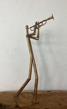 Load image into Gallery viewer, It features abstract, elongated figures of musicians playing various instruments, including a guitar, double bass, trumpet, trombone, saxophone, piano, and drums.