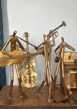 Load image into Gallery viewer, It features abstract, elongated figures of musicians playing various instruments, including a guitar, double bass, trumpet, trombone, saxophone, piano, and drums.