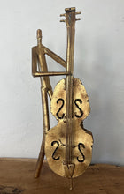 Load image into Gallery viewer, It features abstract, elongated figures of musicians playing various instruments, including a guitar, double bass, trumpet, trombone, saxophone, piano, and drums.