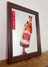 Load image into Gallery viewer, The main image is a unique graphic of an ice-encrusted Estrella Damm bottle held like a popsicle or ice lolly by a hand.