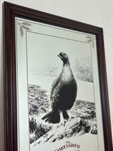 Load image into Gallery viewer, The Famous Grouse advertising wall mirror featuring the brand's iconic red grouse image and the slogan "Quality in an age of change"