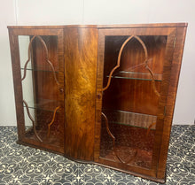 Load image into Gallery viewer, This beautiful piece is a 1930s English Art Deco cocktail cabinet, characterized by its figured walnut veneers and distinctive geometric glazed doors.