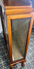 Load image into Gallery viewer, This stunning piece is an antique Art Deco display cabinet, dating from the 1930s. It is characterised by its walnut or mahogany construction, featuring astragal-glazed doors with a distinctive curved pattern and claw-and-ball feet.